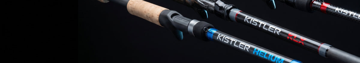 Three Kistler casting rods laid parallel against a near-black background, the Helium and KLX decals in sharp focus